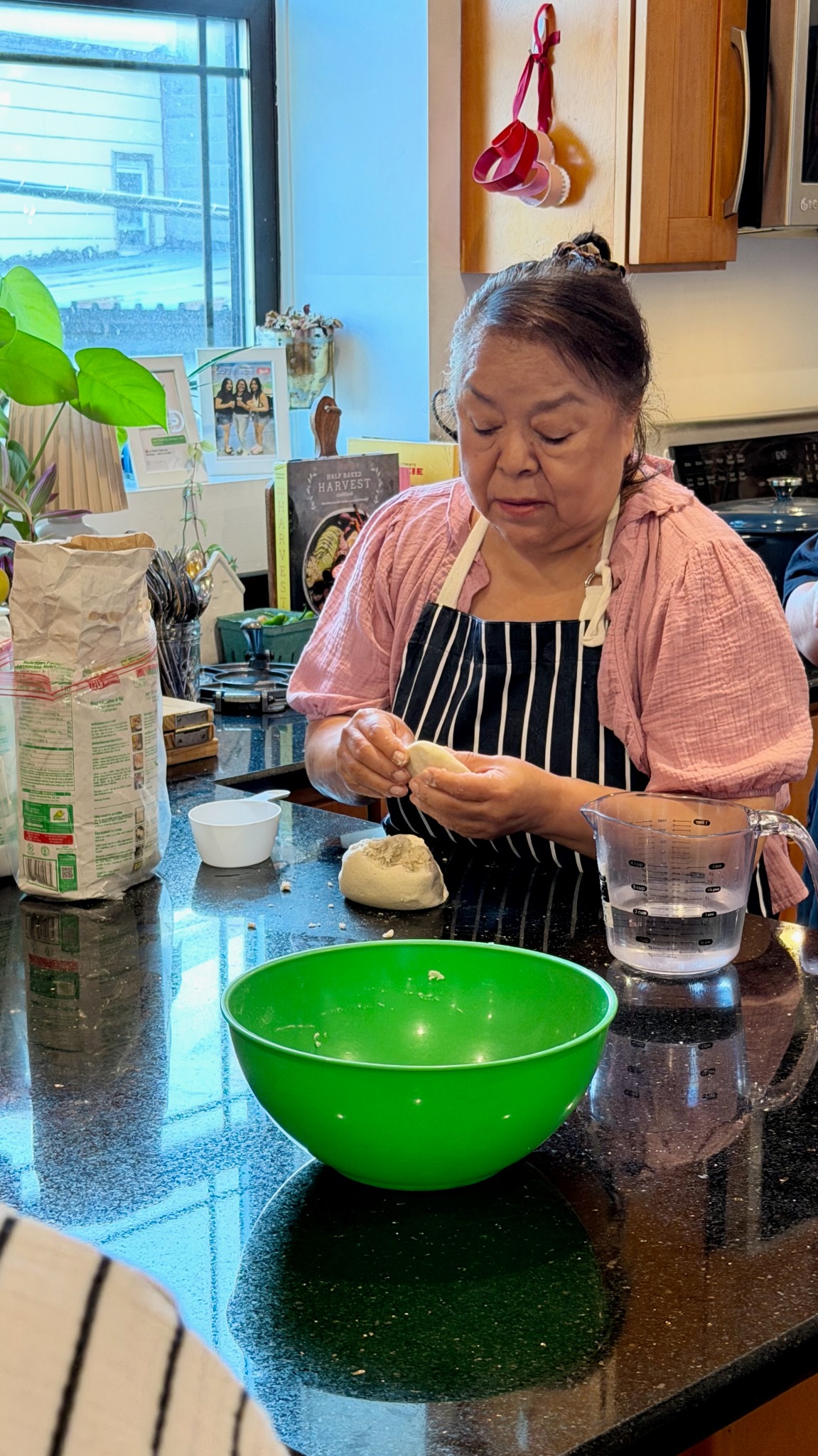 Instructor demonstrating how to shape masa during a Hay Comida en la Casa class