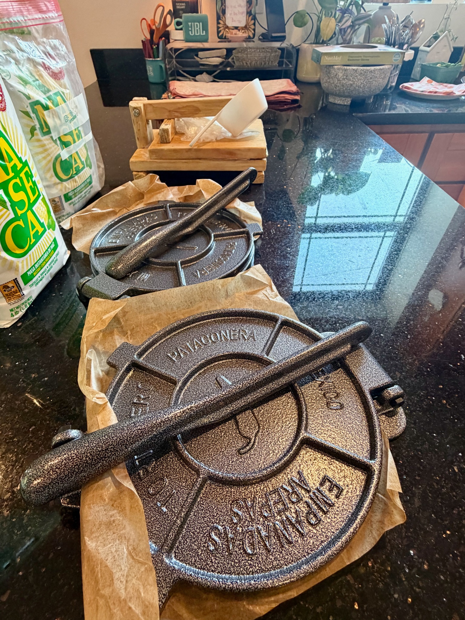 Tortilla presses and masa prepared on the kitchen counter for class